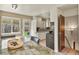 Eat-in kitchen features white cabinets, stainless steel appliances, and access to a fenced backyard at 10645 Moore Ct, Broomfield, CO 80020