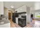 This kitchen features white cabinets, granite countertops, and black appliances at 10645 Moore Ct, Broomfield, CO 80020