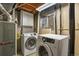 Bright laundry room with modern white Samsung washer and dryer and additional cabinet space at 10645 Moore Ct, Broomfield, CO 80020