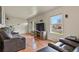 The cozy living room features hardwood floors, a picture window and modern decor at 10645 Moore Ct, Broomfield, CO 80020
