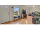 A view of the living room with hardwood floors, natural light, and an entertainment center at 10645 Moore Ct, Broomfield, CO 80020