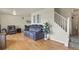 The living room features hardwood floors, neutral paint and a staircase to the second floor at 10645 Moore Ct, Broomfield, CO 80020