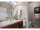 Bathroom with a single sink vanity, large mirror, and a shower/tub combo with tiled walls at 3519 Zane Gray Loop, Parker, CO 80138