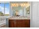 Bright bathroom with a double sink vanity, granite countertops, separate tub, large mirror and a window with views at 3519 Zane Gray Loop, Parker, CO 80138