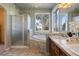 Bathroom featuring a glass shower, soaking tub under window, and a double sink vanity with decorative tile backsplash at 3519 Zane Gray Loop, Parker, CO 80138