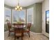 Cozy dining area with a chandelier, bay window with great views, and seating for four at 3519 Zane Gray Loop, Parker, CO 80138