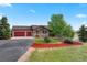 Charming ranch home with a three-car garage, mature landscaping, and manicured lawn at 3519 Zane Gray Loop, Parker, CO 80138