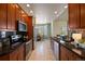Modern kitchen with stainless steel appliances, granite countertops, and a dining area beyond at 3519 Zane Gray Loop, Parker, CO 80138