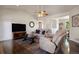 Bright living room featuring hardwood floors, vaulted ceilings, and an open layout to dining area at 3519 Zane Gray Loop, Parker, CO 80138