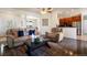 Spacious living room with hardwood floors and open layout flowing into the kitchen and dining area at 3519 Zane Gray Loop, Parker, CO 80138