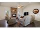 Cozy living room with stone fireplace, vaulted ceilings, and neutral-toned furniture at 3519 Zane Gray Loop, Parker, CO 80138