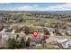 The aerial view highlights lush greenery, the home, and surrounding neighborhoods at 6307 Monterey Pl, Highlands Ranch, CO 80130