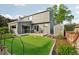 Captivating backyard with a putting green, patio, and shed, all beautifully framed by mature trees and meticulous landscaping at 6307 Monterey Pl, Highlands Ranch, CO 80130
