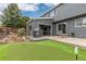 This backyard includes a putting green, covered outdoor grilling station and ample space for outdoor living at 6307 Monterey Pl, Highlands Ranch, CO 80130