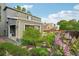 Charming home backyard featuring lush garden, patio, and open garage space for outdoor relaxation and entertaining at 6307 Monterey Pl, Highlands Ranch, CO 80130