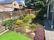 Landscaped backyard with vibrant flowers and stone pathway creating a tranquil outdoor space at 6307 Monterey Pl, Highlands Ranch, CO 80130