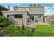Well-maintained backyard featuring a patio with sliding glass doors, artificial turf and tasteful landscaping for outdoor enjoyment at 6307 Monterey Pl, Highlands Ranch, CO 80130