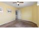 Sunny bedroom with carpeted floors, an open doorway, and ample space for furnishings at 6307 Monterey Pl, Highlands Ranch, CO 80130