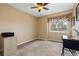 Bedroom featuring a ceiling fan, window and neutral carpet at 6307 Monterey Pl, Highlands Ranch, CO 80130