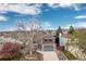 The exterior shot showcases a well-maintained home with an attached two-car garage at 6307 Monterey Pl, Highlands Ranch, CO 80130