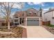 Charming two-story home with a landscaped front yard and attached two-car garage at 6307 Monterey Pl, Highlands Ranch, CO 80130