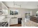 Well-lit kitchen with white cabinets, granite countertops, and modern appliances at 6307 Monterey Pl, Highlands Ranch, CO 80130