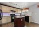 Modern kitchen featuring granite countertops, an island, and stainless steel appliances at 6307 Monterey Pl, Highlands Ranch, CO 80130