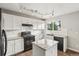 Modern kitchen with white cabinets, granite countertops, and stainless appliances at 6307 Monterey Pl, Highlands Ranch, CO 80130