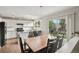 Bright kitchen with white cabinets, stainless steel appliances, and a dining area at 6307 Monterey Pl, Highlands Ranch, CO 80130