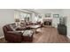 Bright living room with hardwood floors, a fireplace, and ample seating at 6307 Monterey Pl, Highlands Ranch, CO 80130