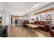 Spacious living room with hardwood floors and a view into the adjacent kitchen at 6307 Monterey Pl, Highlands Ranch, CO 80130