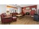 Inviting living room with a brick fireplace and hardwood flooring at 6307 Monterey Pl, Highlands Ranch, CO 80130