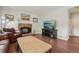 Cozy living room featuring a brick fireplace and comfortable leather seating at 6307 Monterey Pl, Highlands Ranch, CO 80130