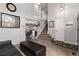 Open-concept living room with a staircase and view into the adjacent dining room at 6307 Monterey Pl, Highlands Ranch, CO 80130