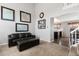 Cozy living room featuring neutral walls and an adjacent view to the kitchen area at 6307 Monterey Pl, Highlands Ranch, CO 80130