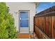 A well-maintained backdoor entrance that features a storm door and a green shrubbery, increasing curb appeal at 3100 W 94Th Ave, Westminster, CO 80031