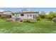 Charming backyard featuring a brick patio, well-maintained lawn, and solar panels on the roof at 3100 W 94Th Ave, Westminster, CO 80031