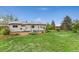 Expansive backyard offers a brick patio, seating, green grass, and great outdoor living space at 3100 W 94Th Ave, Westminster, CO 80031