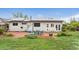Home's backyard has a brick patio with outdoor seating, a fire pit, and a well-manicured lawn at 3100 W 94Th Ave, Westminster, CO 80031
