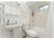 Compact bathroom features a pedestal sink, toilet, and tiled shower/tub, maximizing space and functionality at 3100 W 94Th Ave, Westminster, CO 80031