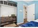 Comfortable bedroom features wood-look floors, dresser, and organized closet space at 3100 W 94Th Ave, Westminster, CO 80031