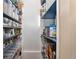 Walk-in pantry showcasing organized shelving with clear containers for storage at 3100 W 94Th Ave, Westminster, CO 80031