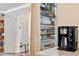 Walk-in pantry with lots of shelves for storage and a coffee maker on the counter at 3100 W 94Th Ave, Westminster, CO 80031