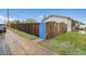 A wooden privacy fence is enhanced by a bright blue gate, nestled within a green yard at 3100 W 94Th Ave, Westminster, CO 80031