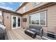 Back deck with outdoor fire pit, seating, and an exterior view of the home at 7315 Blue Water Dr, Castle Rock, CO 80108