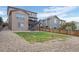 Backyard with grass area, rock landscaping, and a view of the exterior and outdoor stairs at 7315 Blue Water Dr, Castle Rock, CO 80108