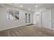 Finished basement with neutral walls and carpets, recessed lighting and double doors at 7315 Blue Water Dr, Castle Rock, CO 80108
