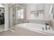 Bathroom showcasing a shower and soaking tub with a large window for natural light at 7315 Blue Water Dr, Castle Rock, CO 80108