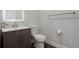 Modern half bathroom with a sink, toilet, and vanity at 7315 Blue Water Dr, Castle Rock, CO 80108