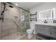 Updated bathroom features modern vanity, accent mirror, tiled walk-in shower, and wood look floors at 7315 Blue Water Dr, Castle Rock, CO 80108